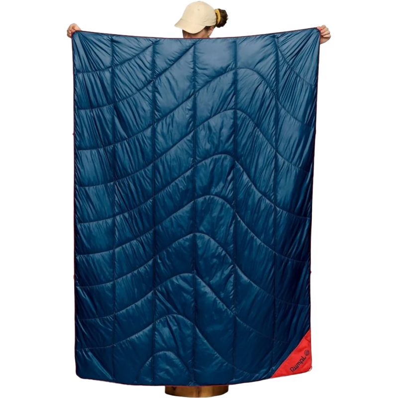 The Backcountry Puffy Blanket, Rumpl The Backcountry Puffy Blanket in Deepwater held up by model