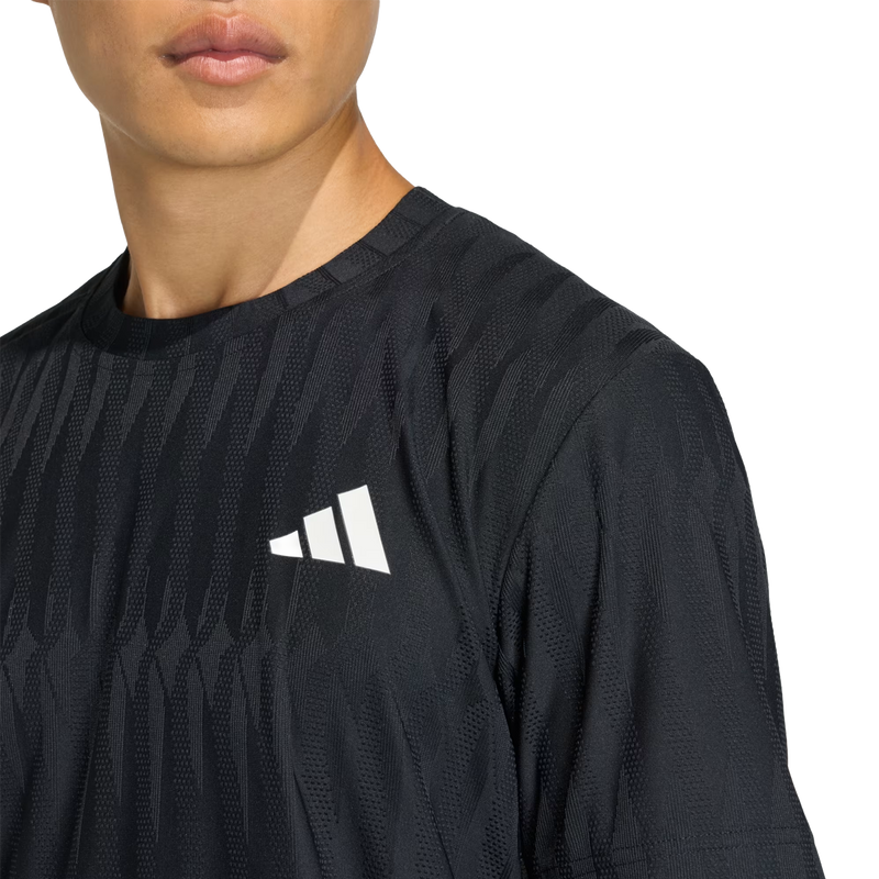 Men's FreeLift Tee, Adidas Men's FreeLift Tee in Black with logo and texture detail