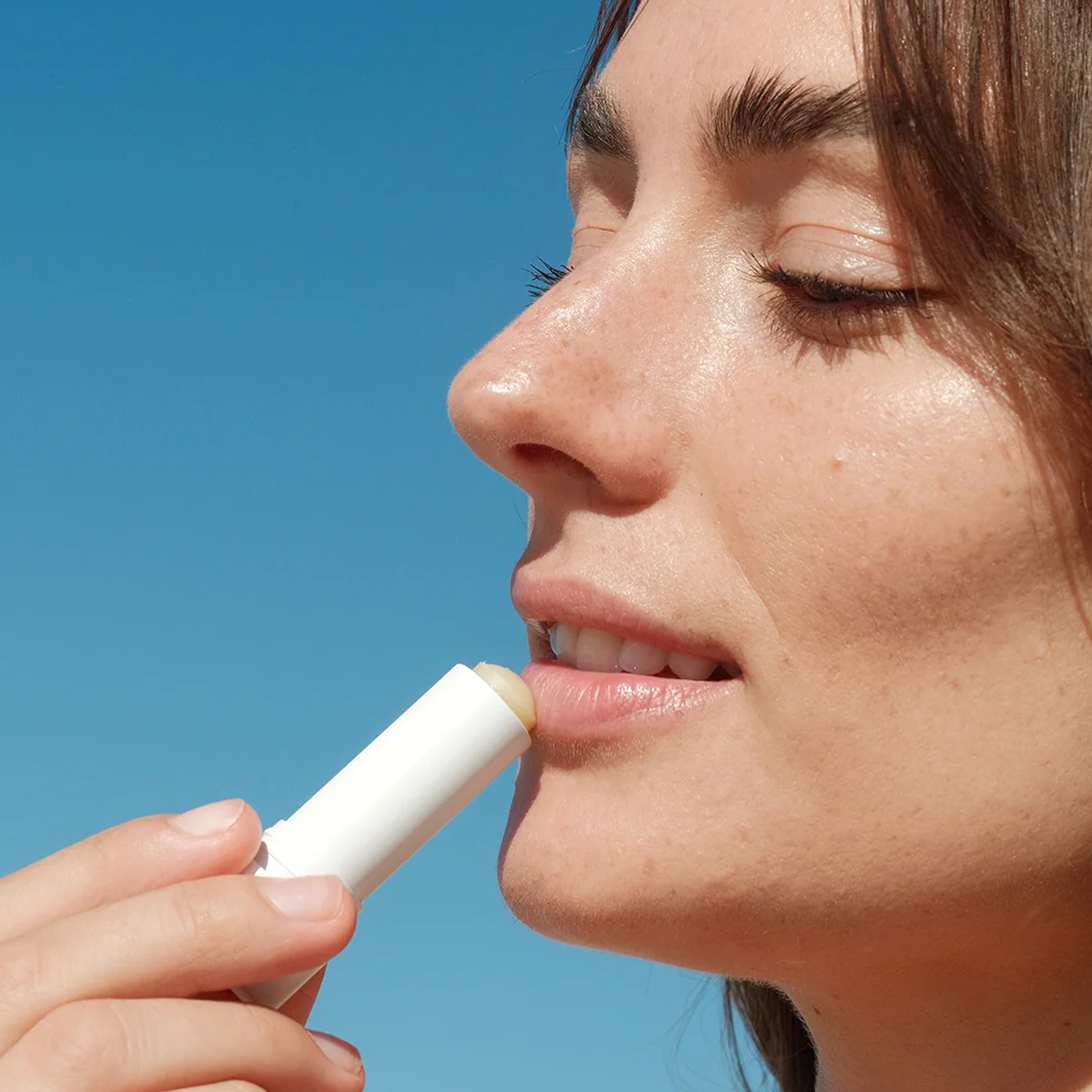 COOLA Travel Essentials Original Liplux® Lip Balm Sunscreen being put on lips