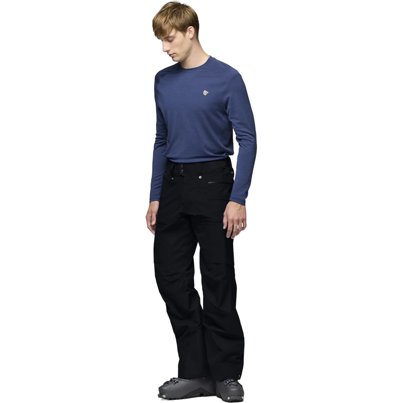 Norrona Lofoten Gore-Tex Pants in Caviar Black on model with ski boots