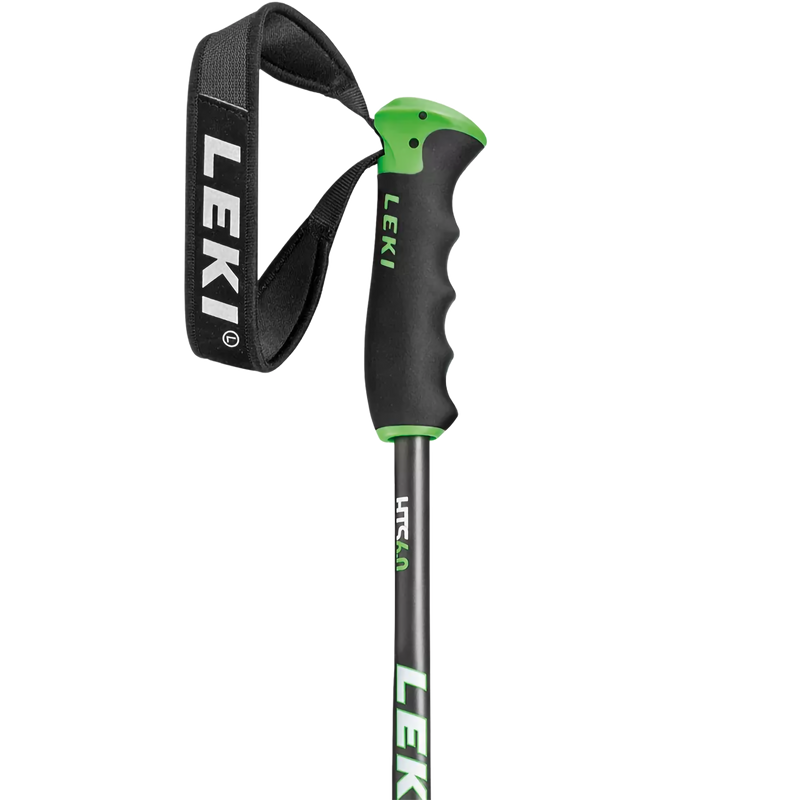 A close-up of a Leki hiking pole with a black and green ergonomic handle, a black wrist strap with white Leki branding, and a dark gray shaft with green and white branding.