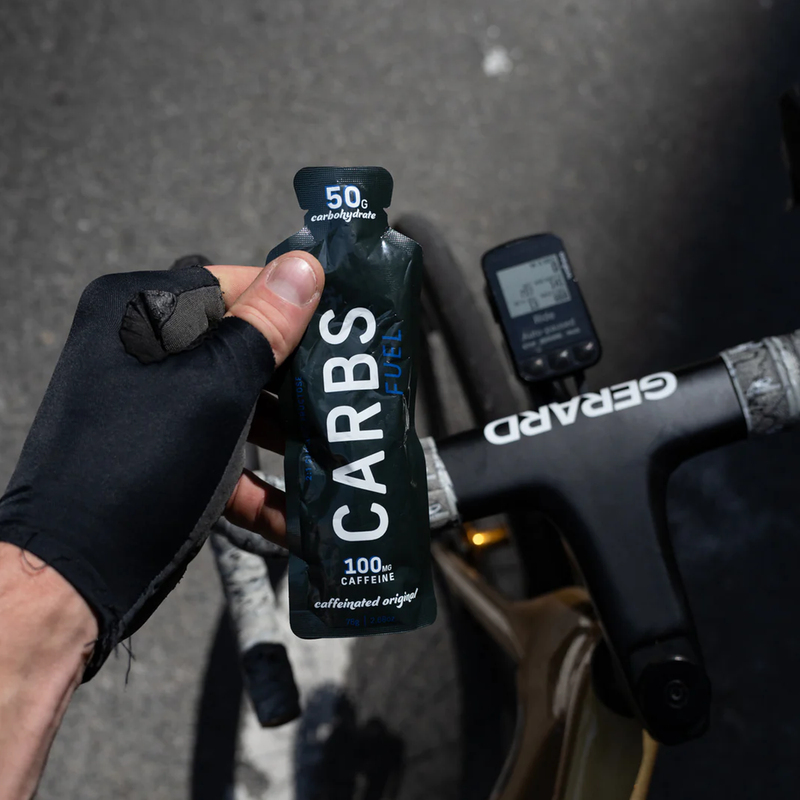Caffeinated Original 50g Energy Gel, Carbs Fuel Caffeinated Original 50g Energy Gel in hand over handlebars