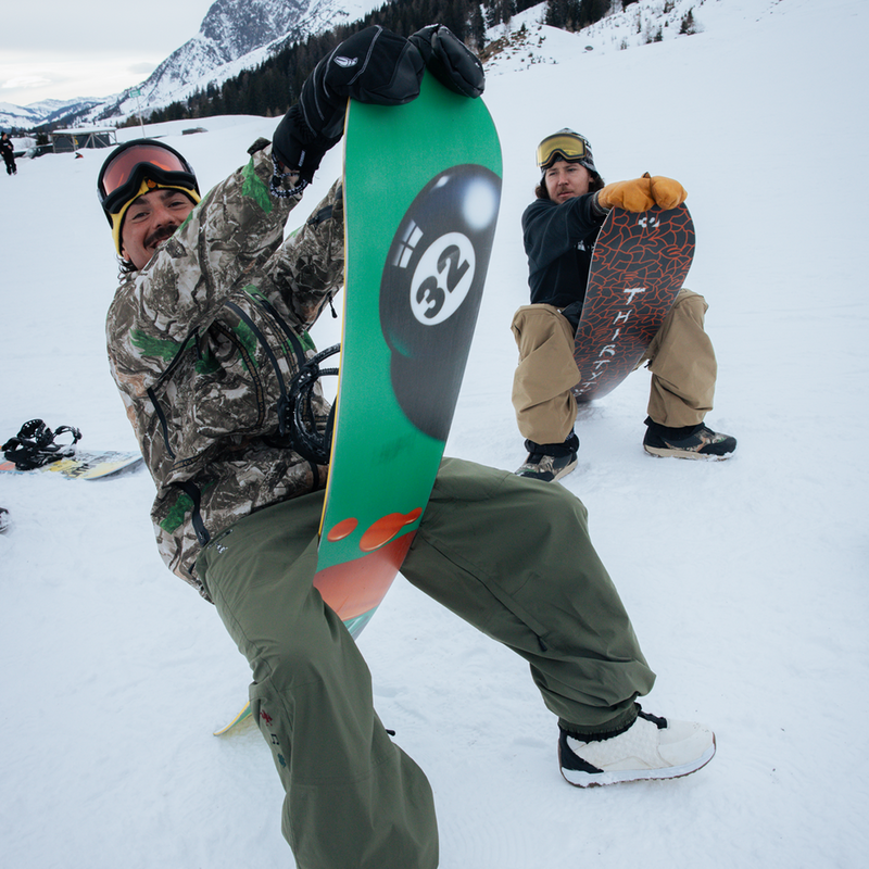 ThirtyTwo XXX Fava Pro with snowboarders sitting on boards on snow