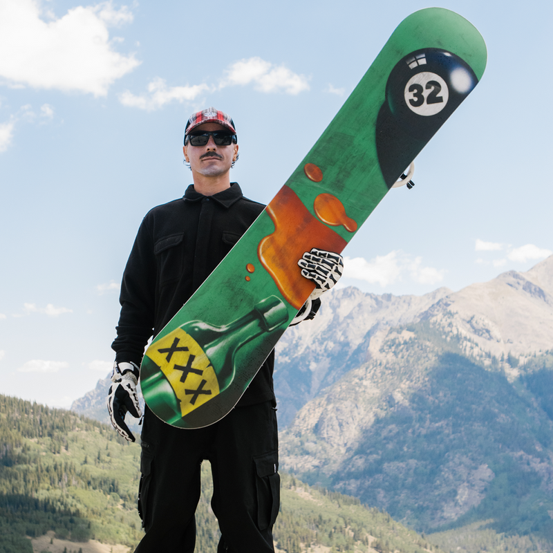 ThirtyTwo XXX Fava Pro with snowboarder holding board towards camera showing base