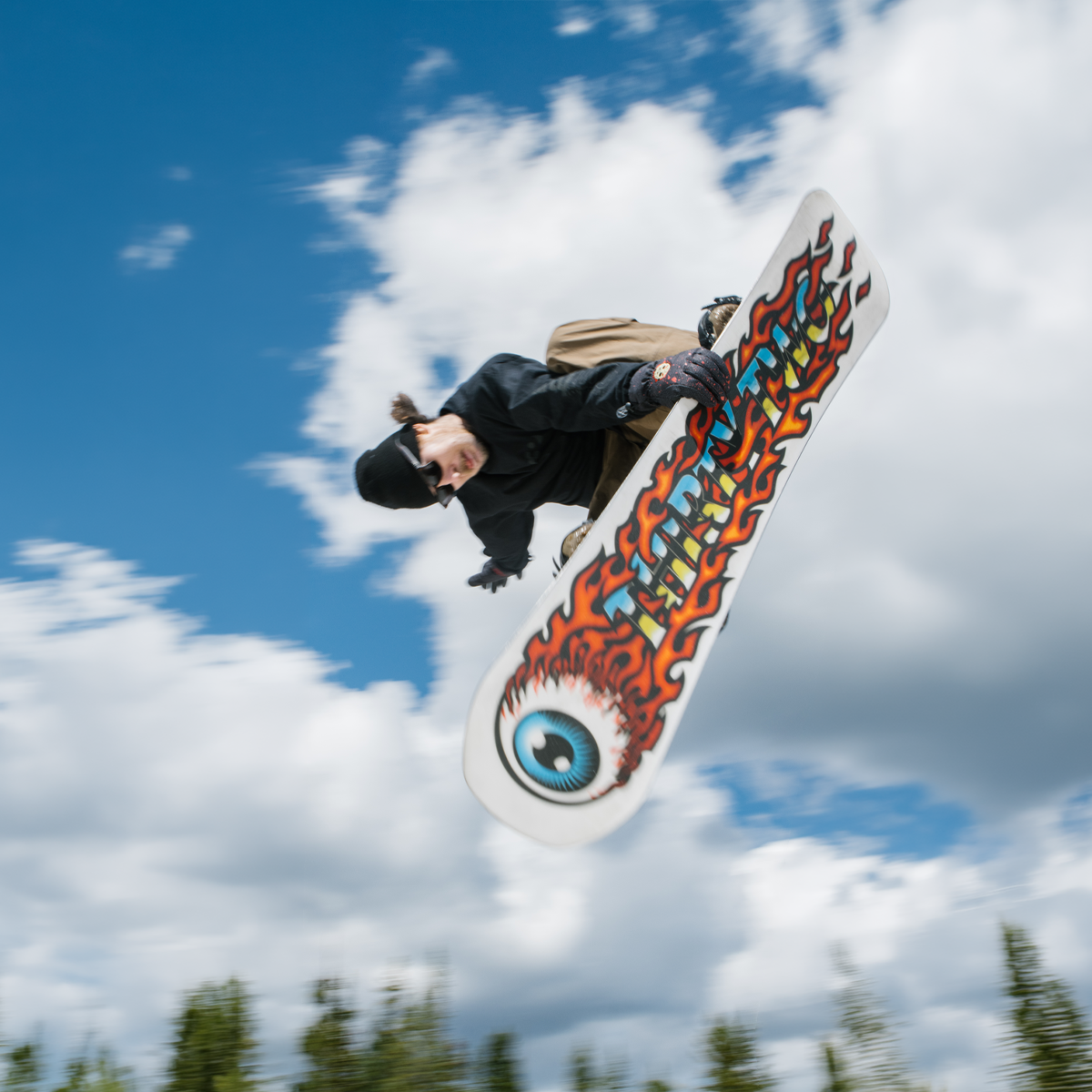 ThirtyTwo Cold World snowboarder doing overhead trick in the air