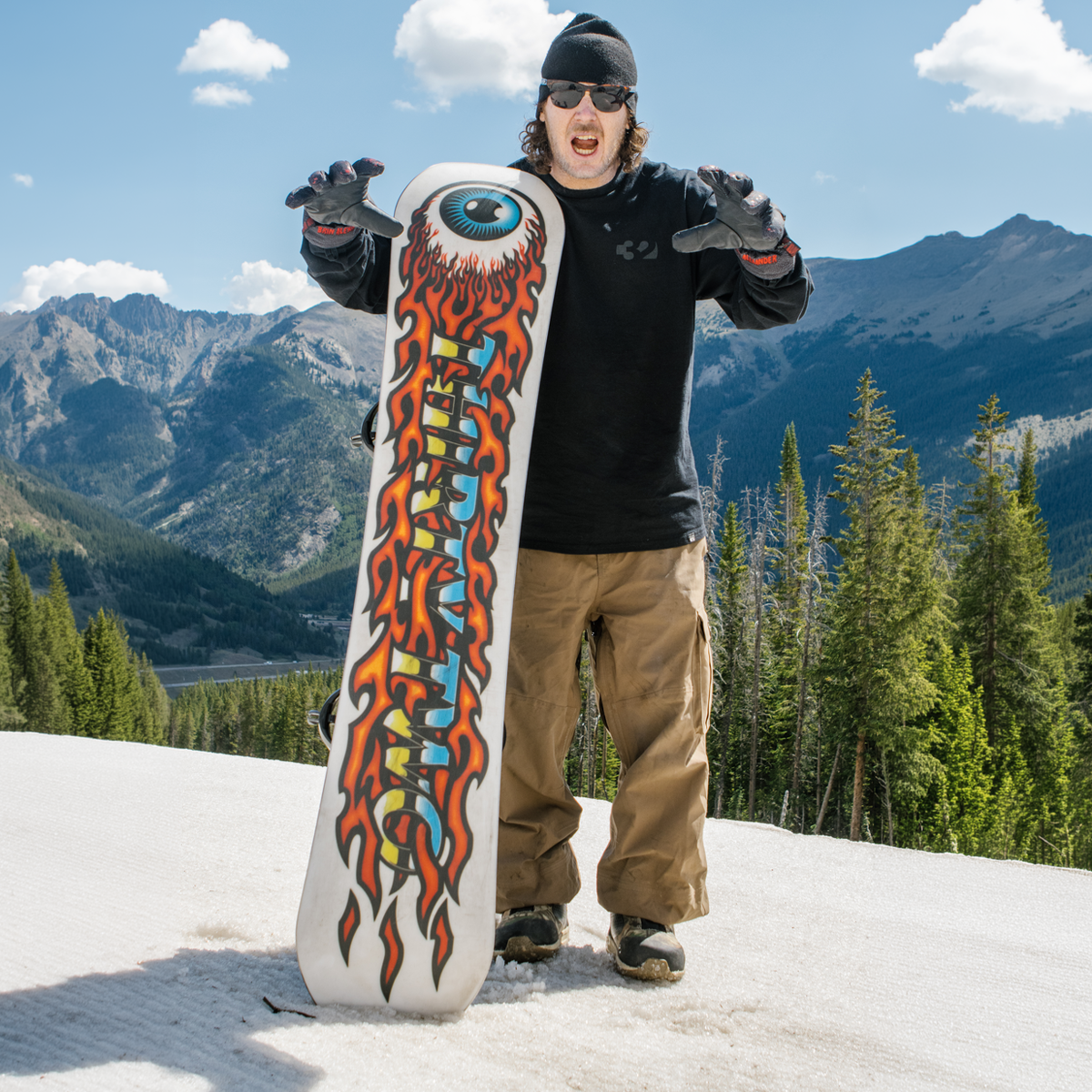 ThirtyTwo Cold World snowboarder with board base side facing camera in snow