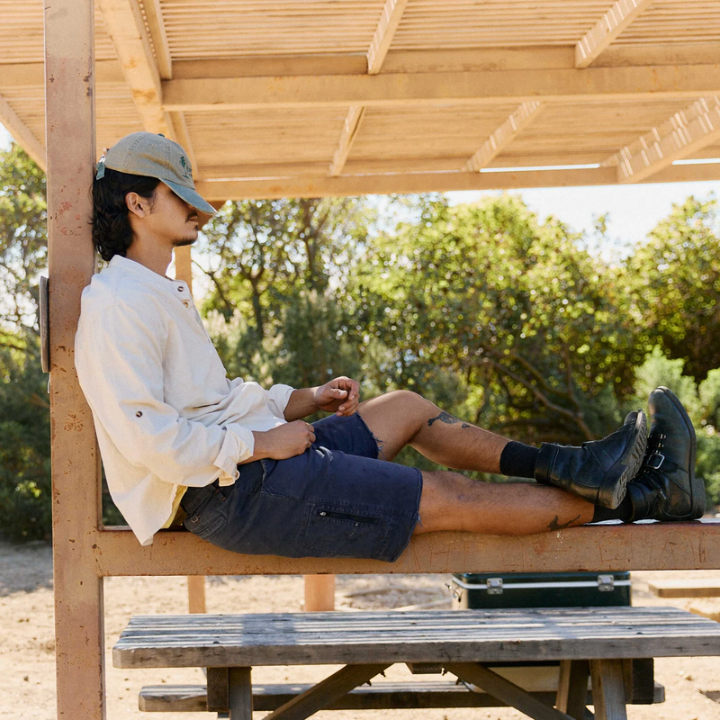 Men's Reggie Deluxe Shorts, Ripton Men's Reggie Deluxe Shorts Cutt-off in Navy on model seated