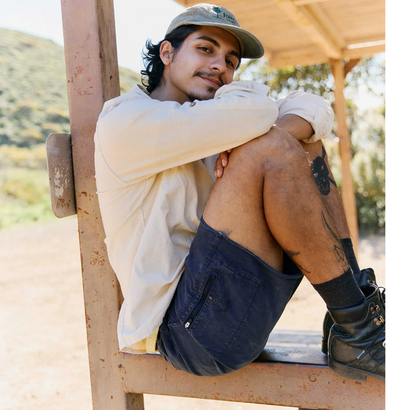 Men's Reggie Deluxe Shorts, Ripton Men's Reggie Deluxe Shorts Cutt-off in Navy on model seated right side