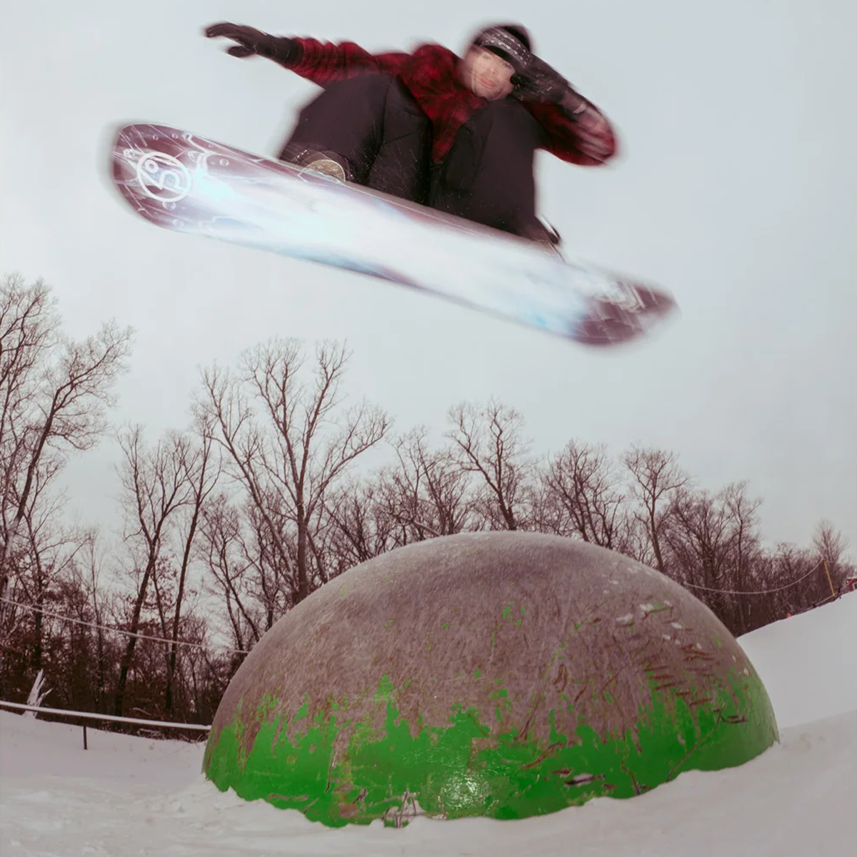 Public Snowboards PUBLIC Dispute with snowboarder jumping over a dome in park
